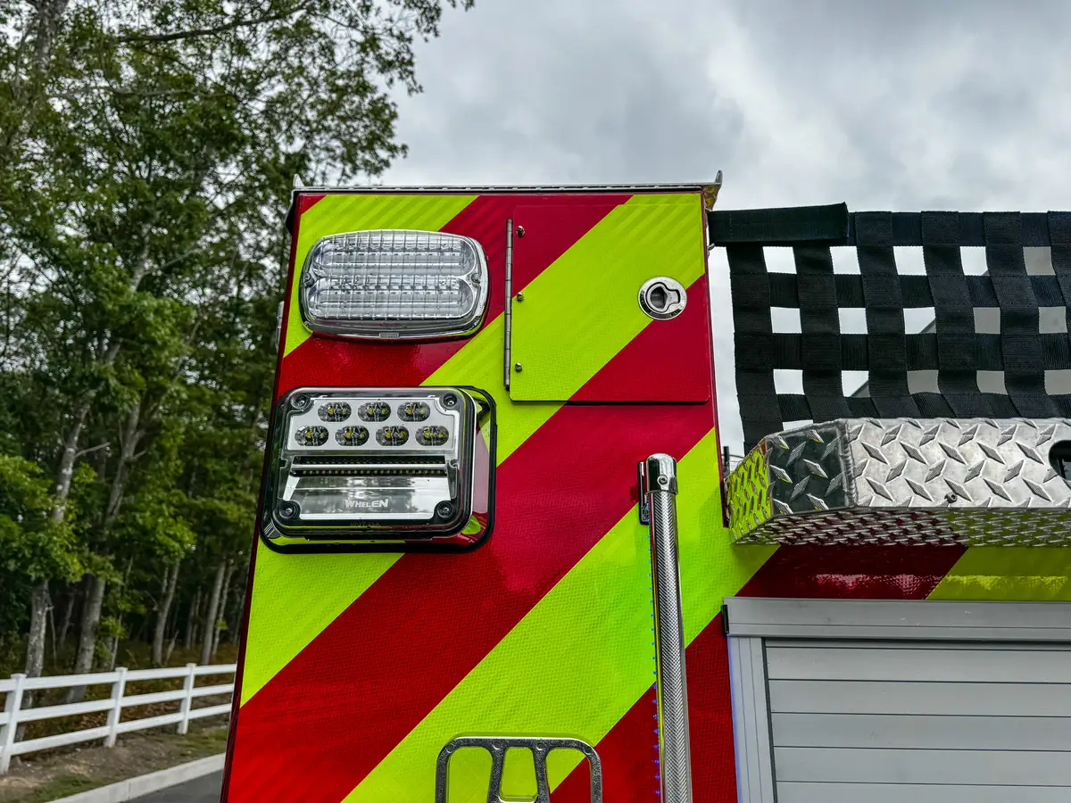 Rear top edge close-up showing hosebed net and upper rear trim.